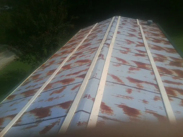 Rusted metal roof panels with new wood purlins before replacement — Storm Damage Roof Repair in Cos Cob by Roofing Brothers