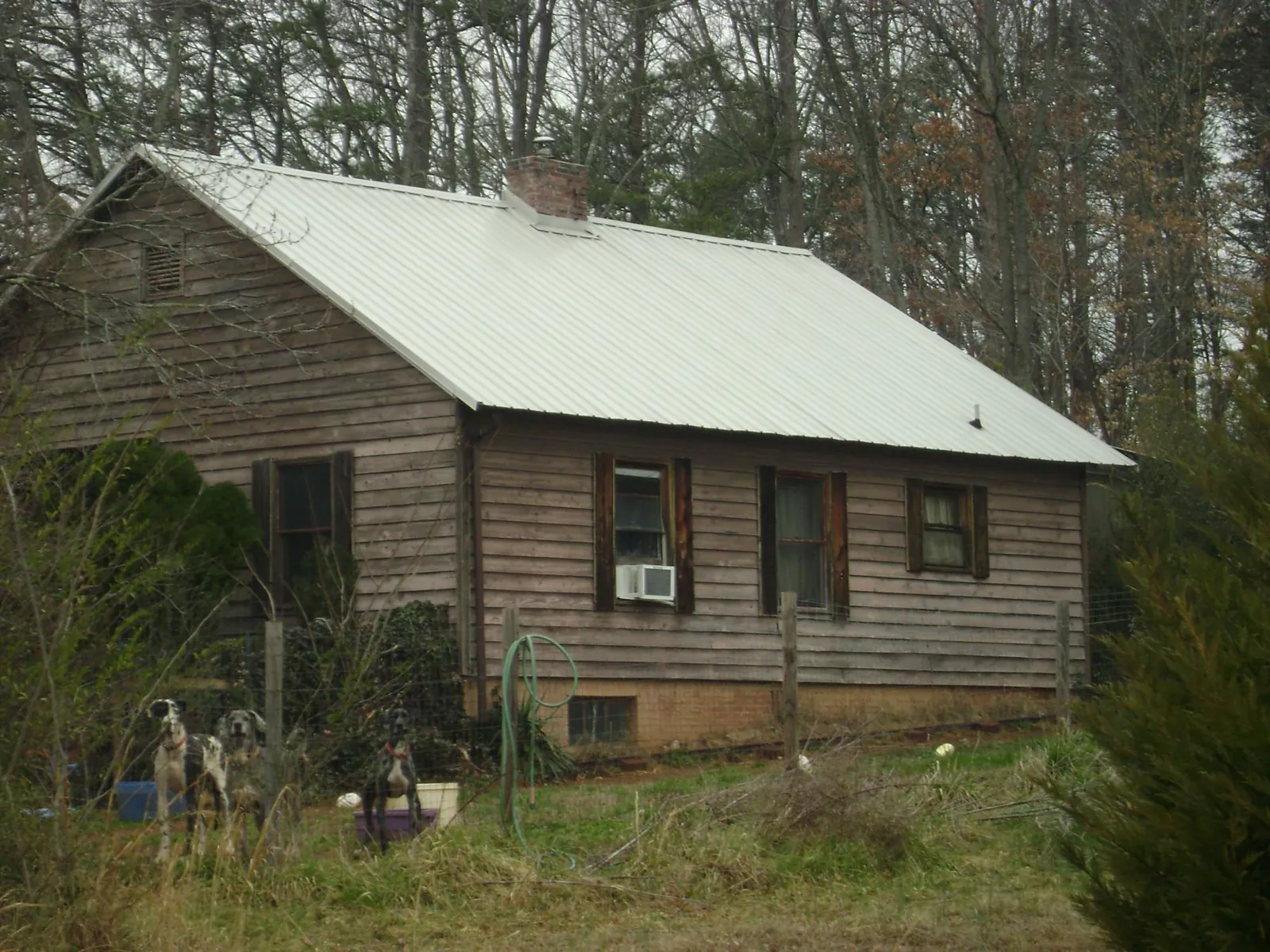 White metal roof on an old wood sided farmhouse, from a Metal Roof Installation job in Cos Cob